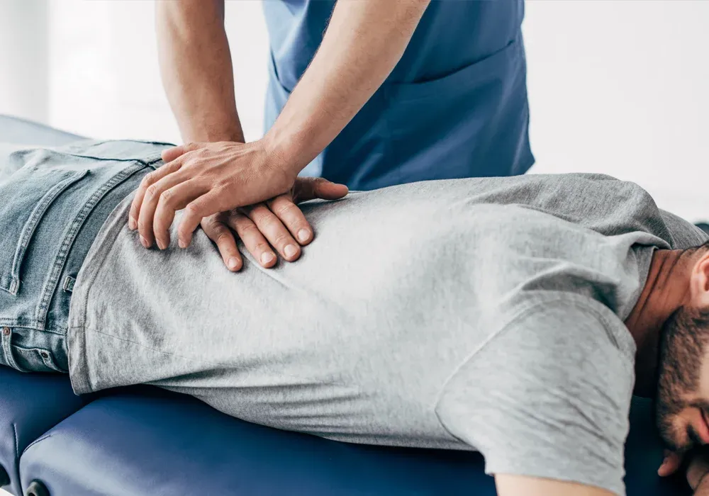 A chiropractor adjusting a patient's lower back